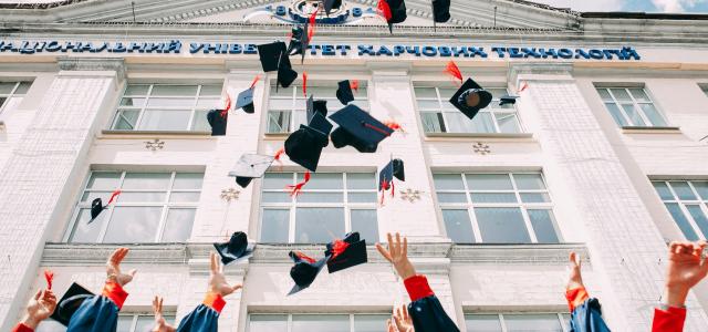group of fresh graduates students throwing their academic hat in the air by Vasily Koloda courtesy of Unsplash.