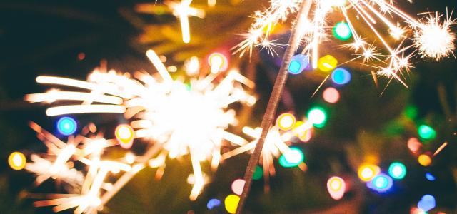 a person is holding a sparkler in their hand by Marisol Benitez courtesy of Unsplash.