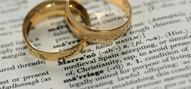 two gold-colored rings on paper by Sandy Millar courtesy of Unsplash.